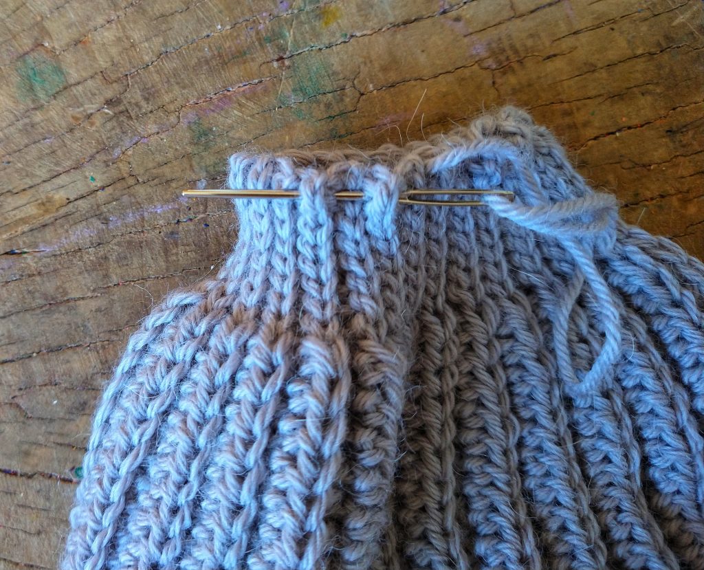closing the top of a simple crochet hat